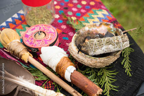 Tela A bundle of sage and an eagle feather are laid out in preparation of a Native American, Indian, or Indigenous smudging ceremony