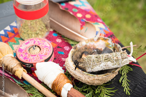 A bundle of sage and an eagle feather are laid out in preparation of a Native American, Indian, or Indigenous smudging ceremony.  Pemberton BC, Canada. ..