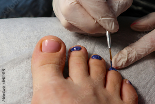 pedicure. painting and design of toe nails. pedicure in a beauty salon