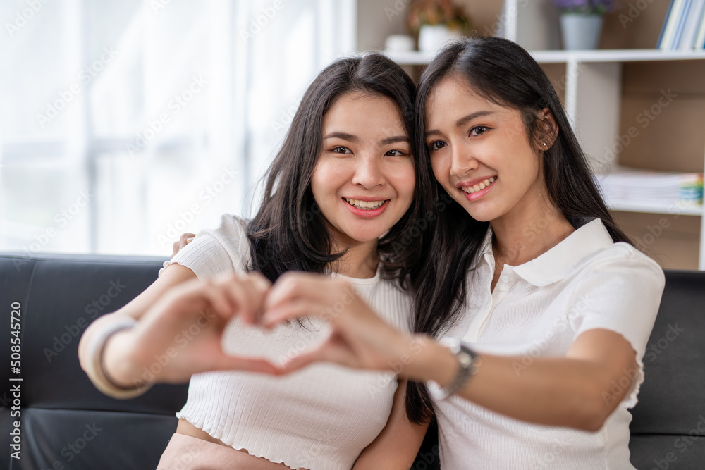 LGBT Lesbian couple love moments happiness , lovely lesbian couple spending time together and having fun at living room, LGBT concept. LGBT Lesbian couple love moments happiness , lovely lesbian couple spending time together and having fun at living room, LGBT concept.