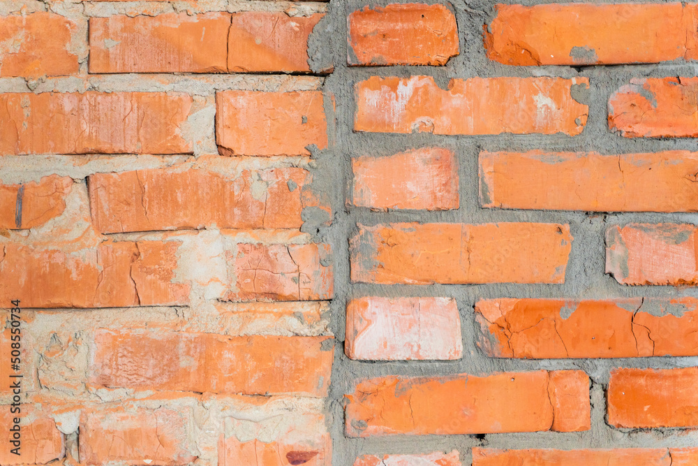 Fototapeta premium Wallpaper from a brick wall. Full screen red brick wall. Construction background