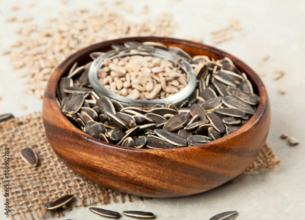 Sunflower oil and sunflower seeds on light background. Sunflower oil and sunflower seeds on light background.