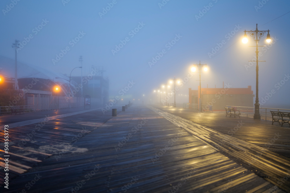 Fototapeta premium Street lights, foggy misty night, lamp post lanterns, deserted road in mist fog. High-quality photo