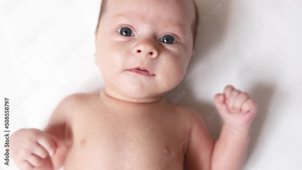 Video portrait of a baby toddler on a white background . Happy baby. A happy child. An infant looks into the camera . White background. High quality FullHD footage Video portrait of a baby toddler on a white background . Happy baby. A happy child. An infant looks into the camera . White background. High quality FullHD footage