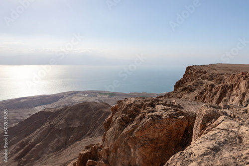 Sunrise over the Dead Sea near mountains of stone desert near the Khatsatson stream, on the Israeli side of the Dead Sea, near Jerusalem in Israel