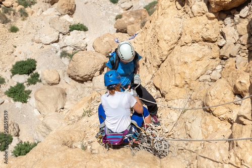 Experienced athletes on Israel Independence Day check equipment before rappel in mountains of Judean Desert, near Khatsatson stream, near Jerusalem, Israel.