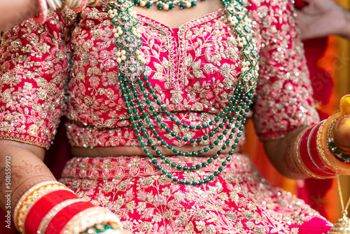 Indian Hindu bride's wearing her jewellery necklace close up