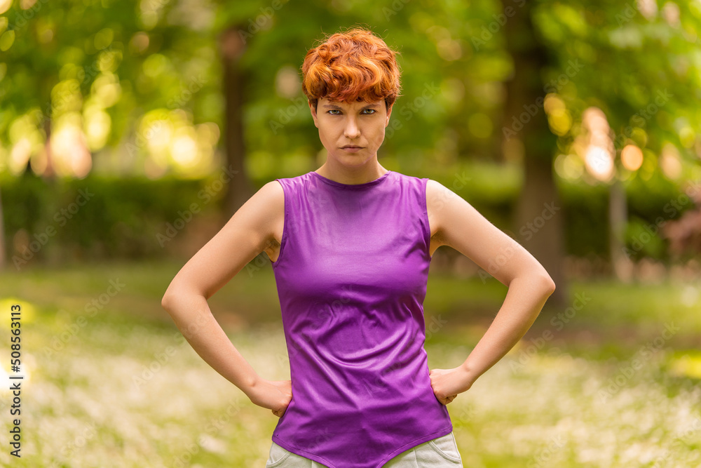 Non-binary gender person with angry expression in a park Non-binary gender person with angry expression in a park