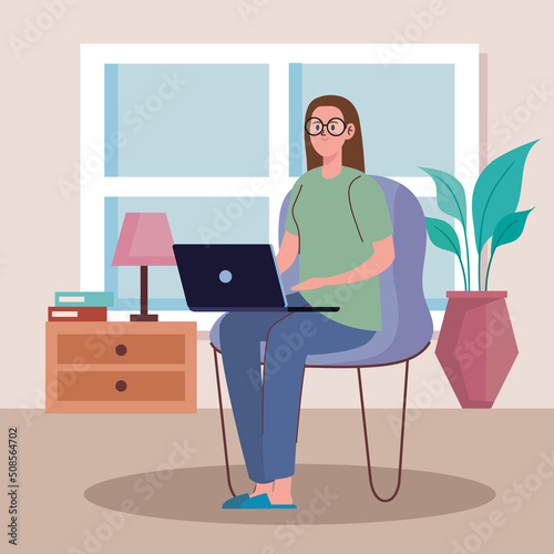 woman using laptop in chair