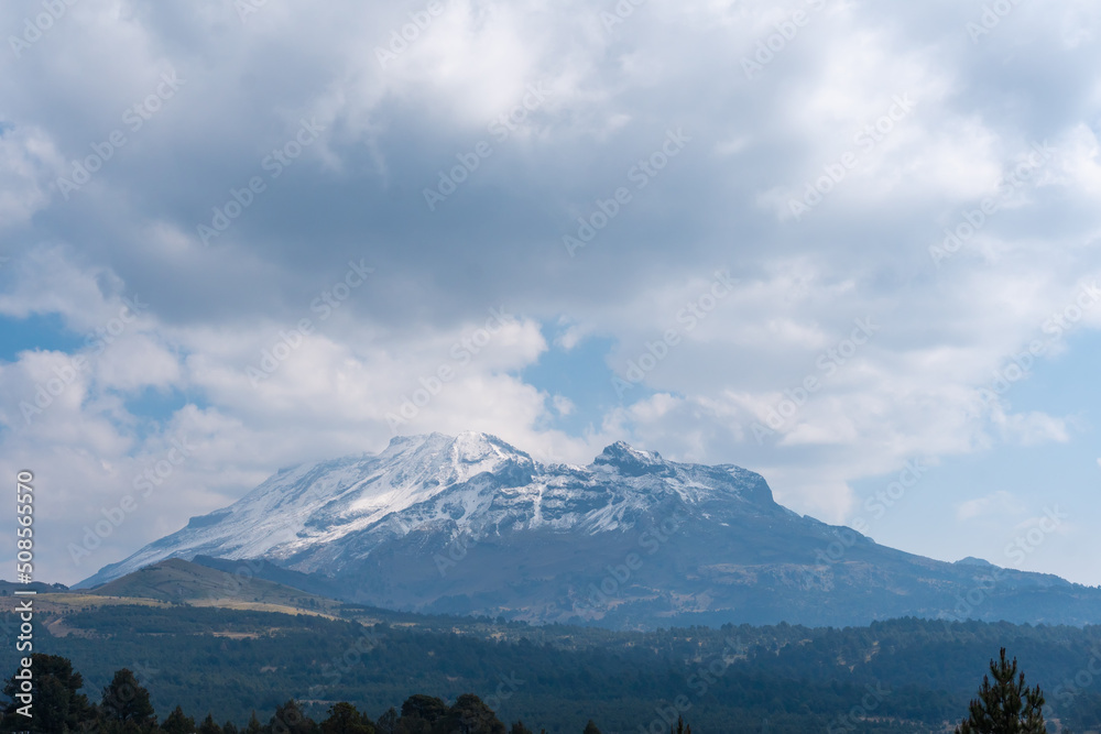 Top of Iztaccihuatl volcano covered with snow.