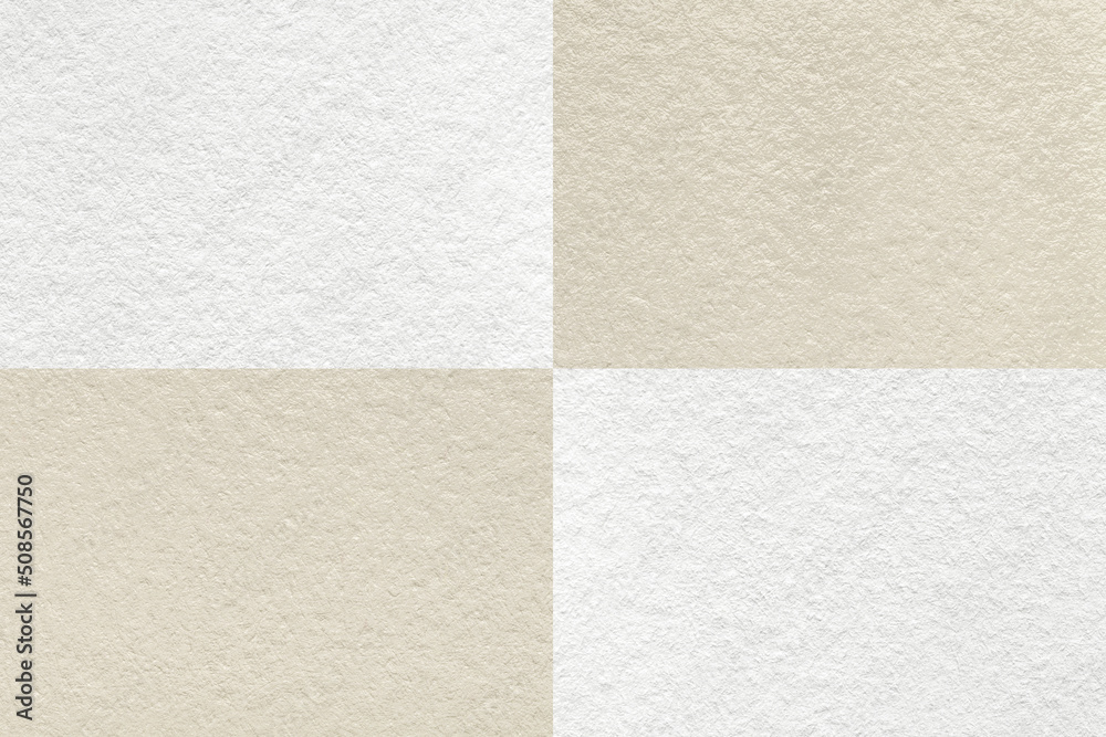 Fototapeta premium Texture of craft light beige and white paper background with cells pattern, macro. Structure of vintage kraft cardboard.
