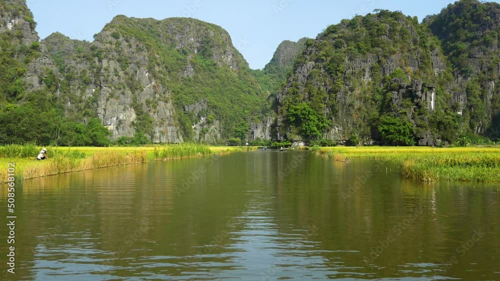 Rice paddies and amazing rock formations along the Sao Khe River near the town of Ninh Binh, Vietnam. Rice paddies and amazing rock formations along the Sao Khe River near the town of Ninh Binh, Vietnam.