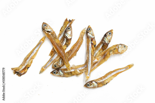 Selective focused on small sun dried fishes Tiny Fish as food ingredient, rich natural source of calcium nutrition over on white background. photo