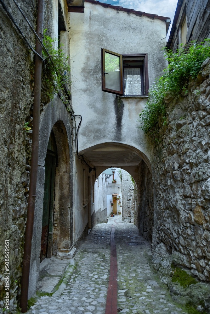 A narrow street between the old houses of Petina, a village in the mountains of Salerno province, Italy.