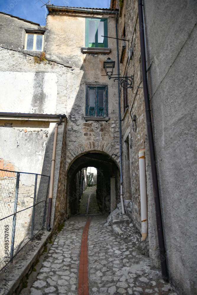Fototapeta premium A narrow street between the old houses of Petina, a village in the mountains of Salerno province, Italy.
