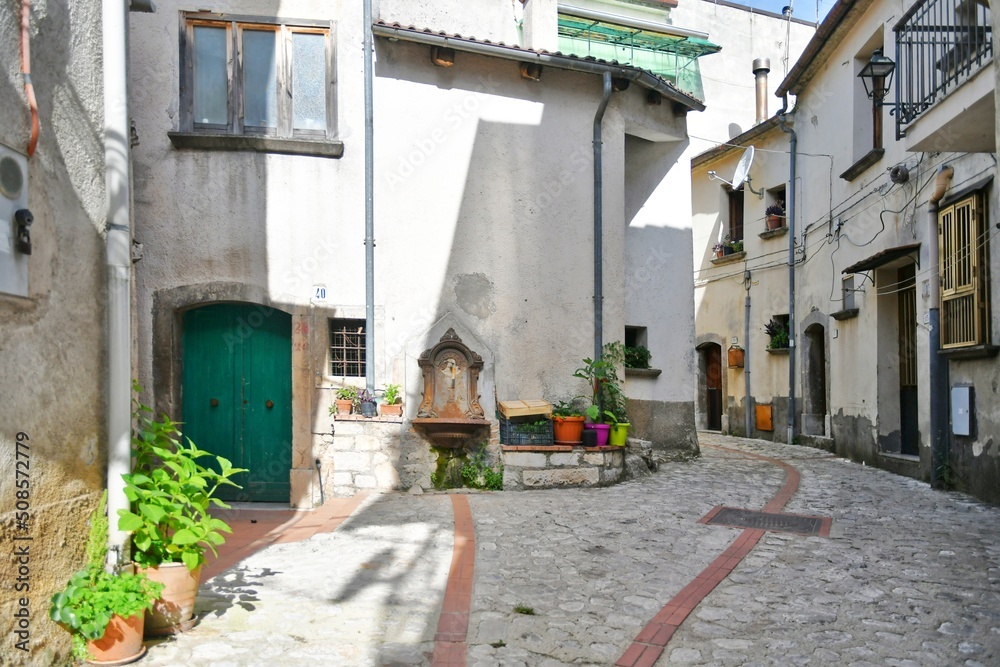 A narrow street between the old houses of Petina, a village in the mountains of Salerno province, Italy.