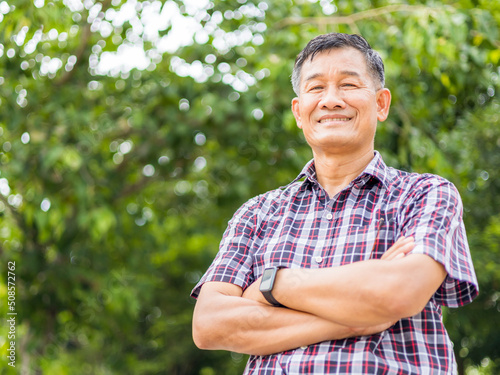 Portrait close-up shot of middle-aged Asian male model with short black hair wearing a plaid shirt.