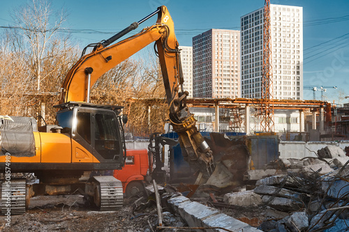 Excavator destroyer removes debris Building demolition