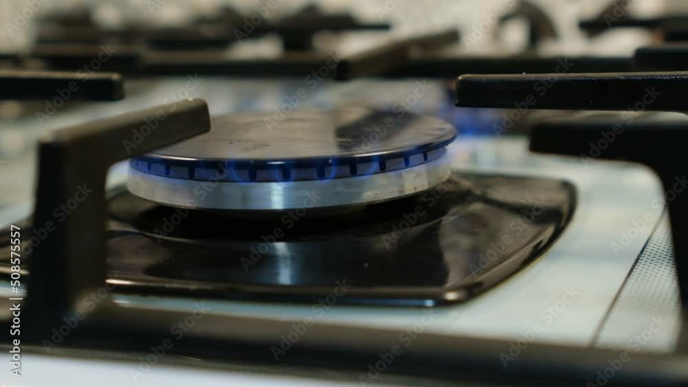 family house kitchen blue and yellow flame gas stove cooker Closeup family house kitchen blue and yellow flame gas stove cooker Closeup