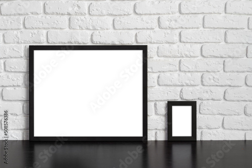 Blank picture frame against brick wall with copy space © fotofabrika