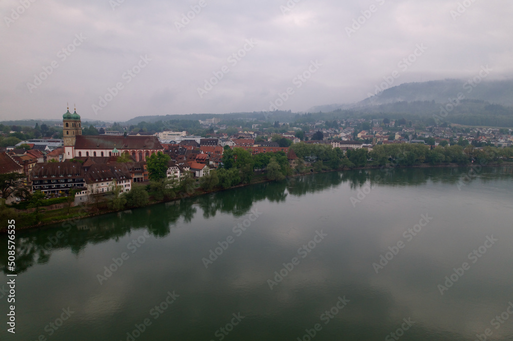 City of Bad Säckingen, Baden-Württemberg, with church and Rhine River on a cloudy spring day. Photo taken May 6th, 2022, Stein, Switzerland.