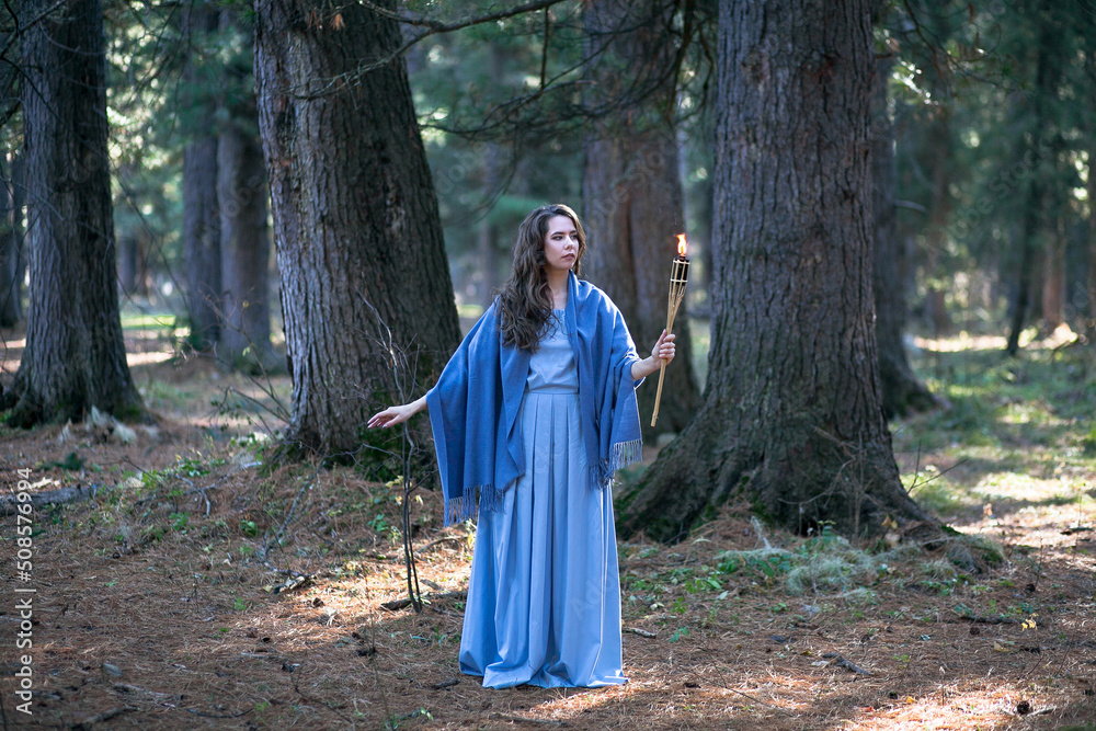 Girl with a torch in the forest. The girl got lost in the forest. Torch. Girl with a torch in the forest. The girl got lost in the forest. Torch.