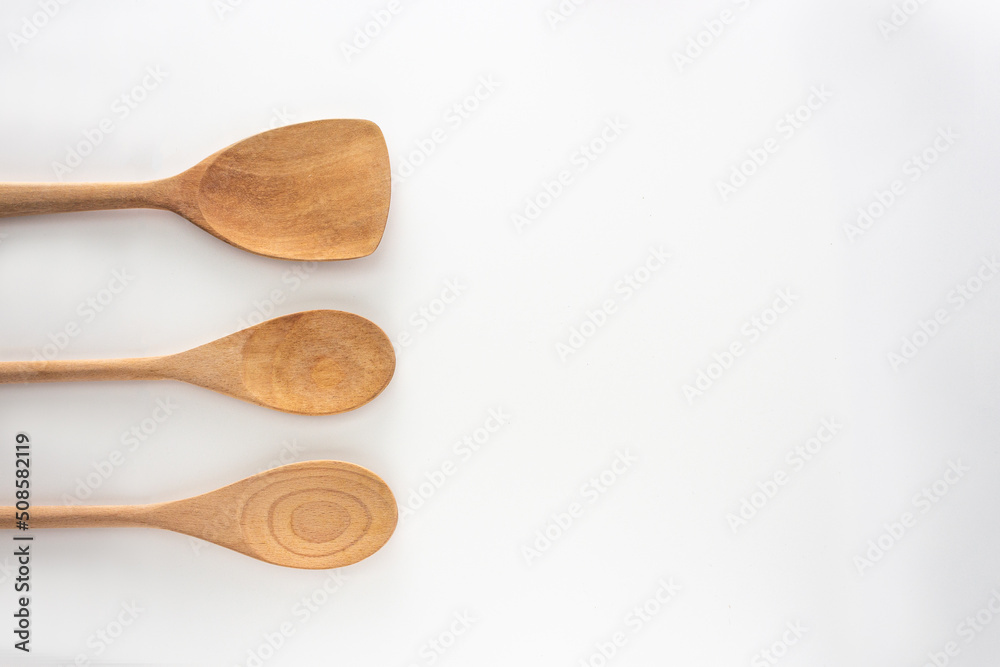 Wooden kitchen tools, spoon and spatula, top view shot on white background. Wooden kitchen tools, spoon and spatula, top view shot on white background.