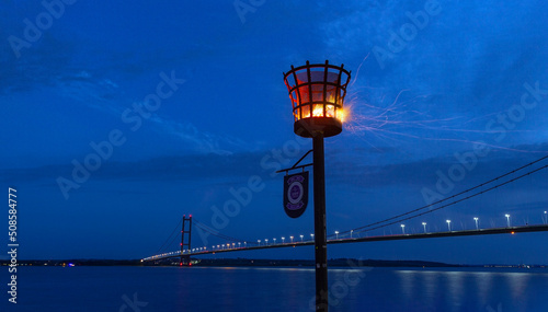 Humber Bridge with Hessle Foreshore beacon lit up for the Diamond Jubilee celebrations, June 2nd 2022. © bluesun