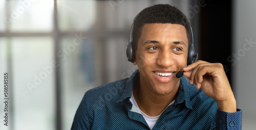 Tablou pe pânză Portrait of African american young male customer support call center operator or