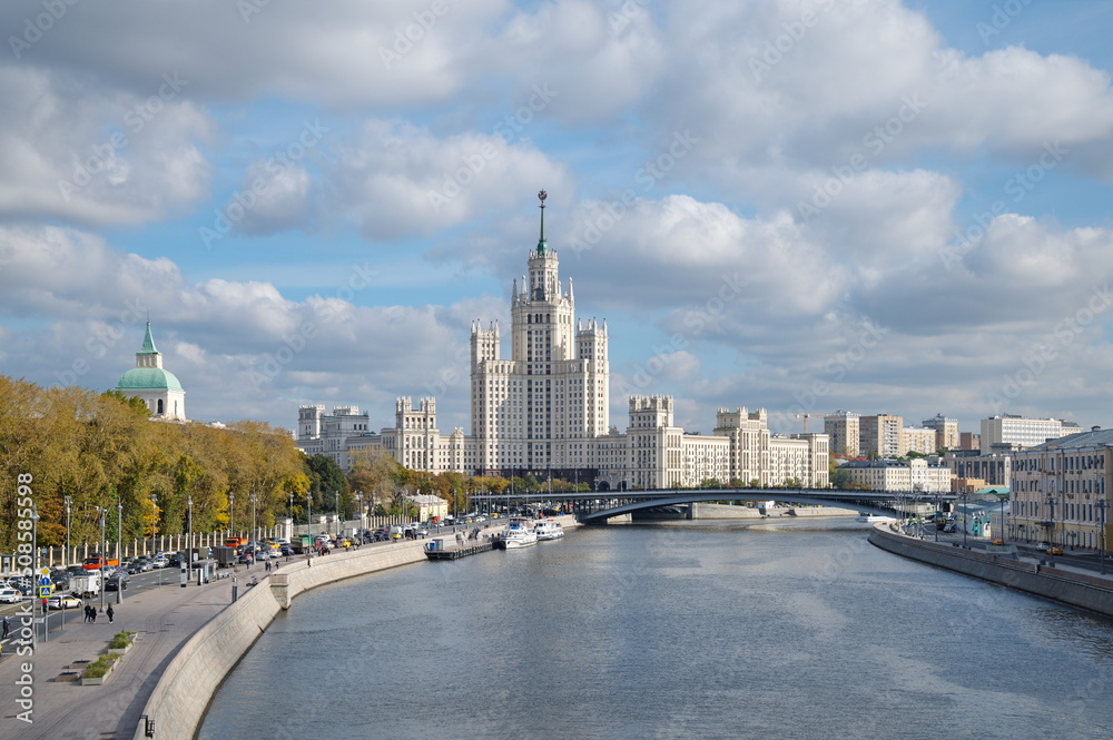 Moscow, Russia - September 29, 2021: Autumn view of Moskvoretskaya embankment and a high-rise building on Kotelnicheskaya embankment