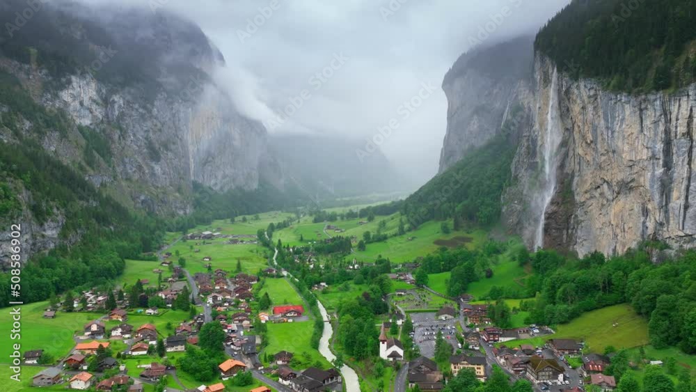 beautiful foggy Lauterbrunnen valley in Switzerland, scenic Swiss alpine village with waterfalls and fog, aerial view of famous natural landmark in Switzerland