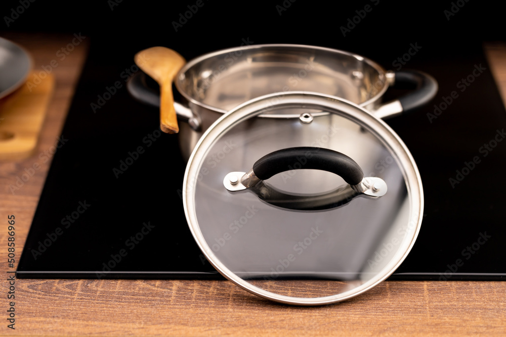 Transparent glass lid for dishes in the kitchen interior Transparent glass lid for dishes in the kitchen interior