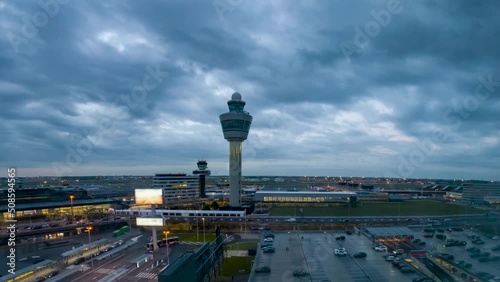 Nighttime at the Schiphol International Airport in Amsterdam and air traffic control tower - time lapse photo
