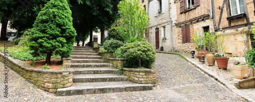 Bild auf Leinwand Littel park with stairs and houses in Bergerac Dordogne region in Southwest of F