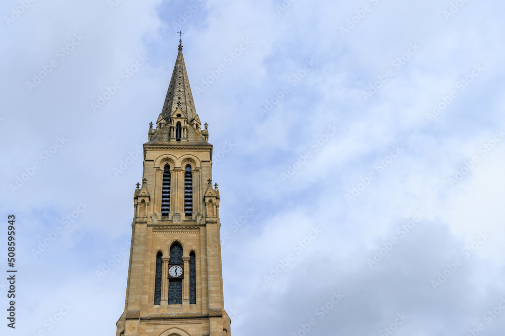 Tower of church Notre Dame against blue sky in in Bergerac Dordogne region in Southwest of France