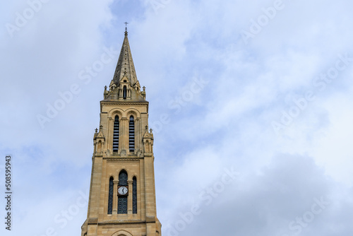 Tower of church Notre Dame against blue sky in in Bergerac Dordogne region in Southwest of France