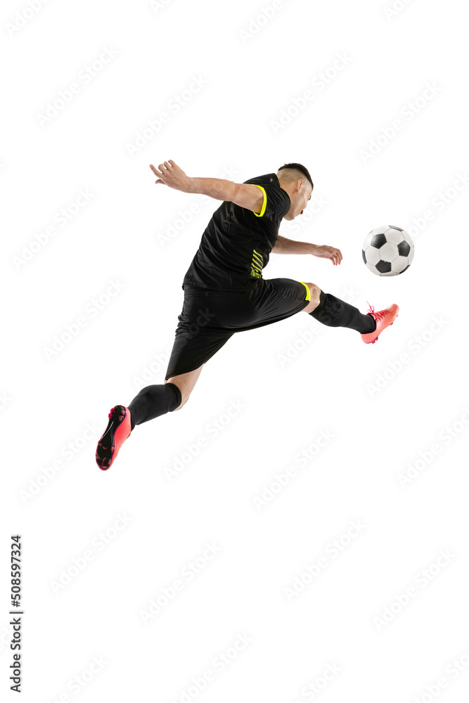 Fototapeta premium Dynamic portrait of professional male football soccer player training isolated on white studio background. Concept of sport, goals, competition, hobby, achievements