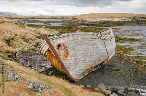 Wreck of an old wooden boat on a small beach in Iceland