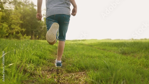 happy family. kid run legs close-up in the park at sunset. people in the park concept boy son joyful run. happy family summer. little baby run child fun summer kid dream lifestyle concept