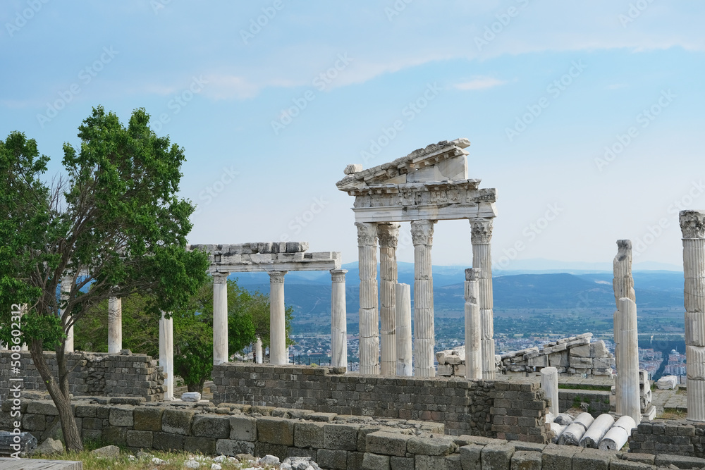 Selective Focus Pergamon Acropolis Ruins. Columns of Temple of Trajan at Acropolis of Pergamon with Tree and Blue Sky in Bergama, Turkey.