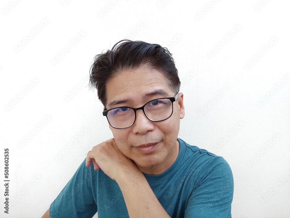 Handsome man with glasses wearing a blue shirt taking a portrait Handsome man with glasses wearing a blue shirt taking a portrait