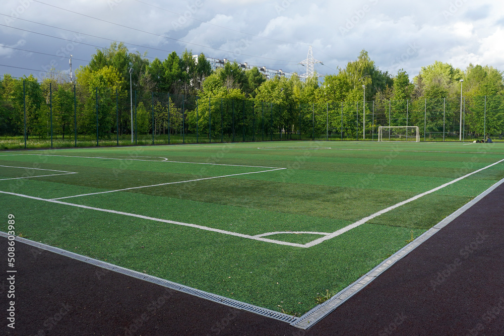 Football court with artificial turf in a public outdoor park