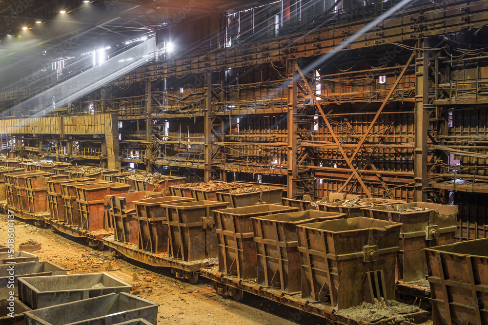 Wagons with scrap metal at steel mill.