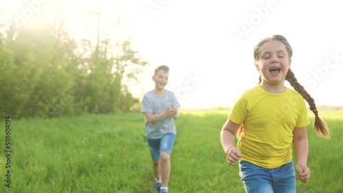 catch-up. children kid dream together run in the park at sunset. happy family people in park concept. boy and girl playing run. baby child running in green meadow. happy family kid fun dream concept