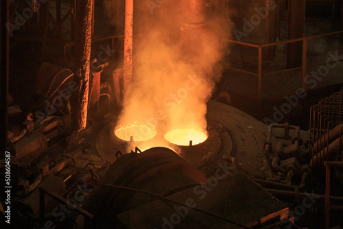 Fototapeta Electric arc furnace in steel mill.