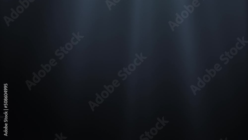 Seamless loop video. Light rays in dark underwater ocean abyss on background darkness. Magical deep ocean waves. Sun light beams illuminating ocean depths. 4K 3D abstract light motion titles cinematic
