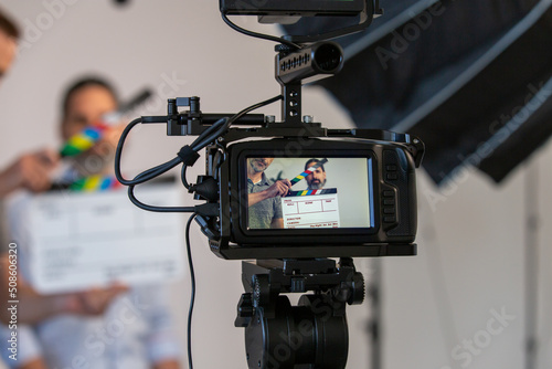 Video Camera and Video Production Studio Set. Actor, Slate Can Be Seen Through Monitor With Blurry Background photo