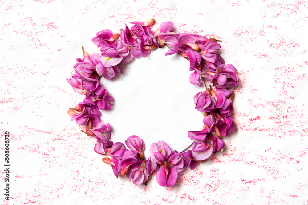 Floral circle frame made from pink acacia flowers