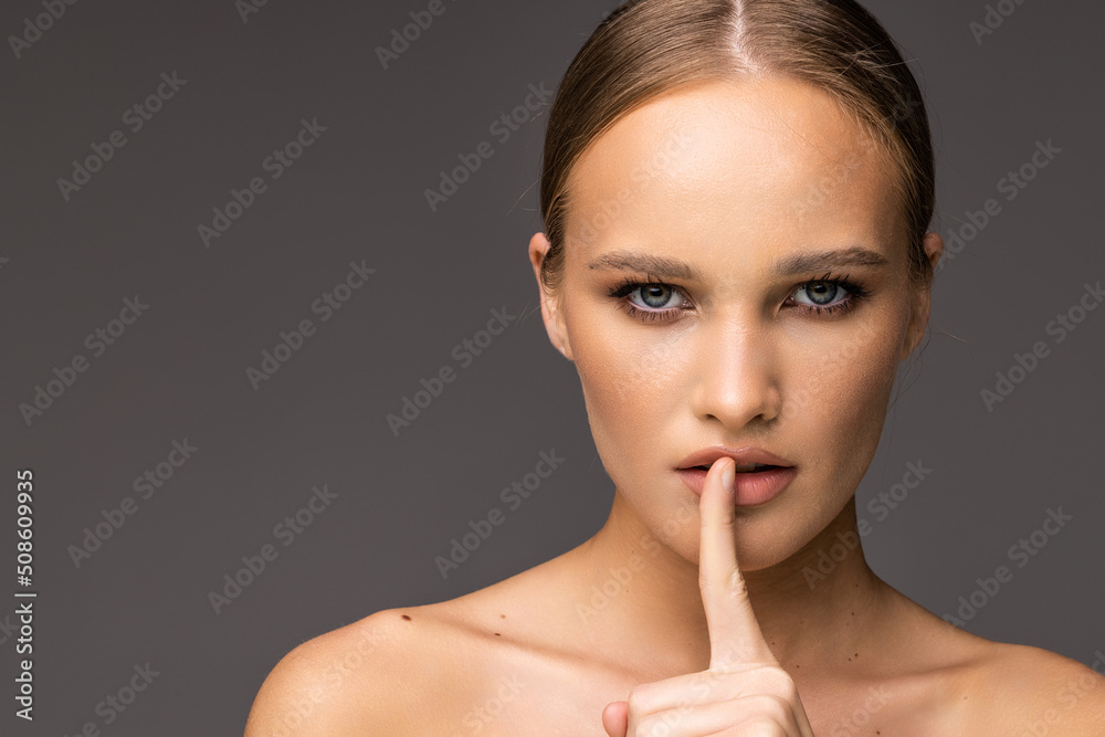 Beautiful young woman showing silence gesture isolated over white background Beautiful young woman showing silence gesture isolated over white background