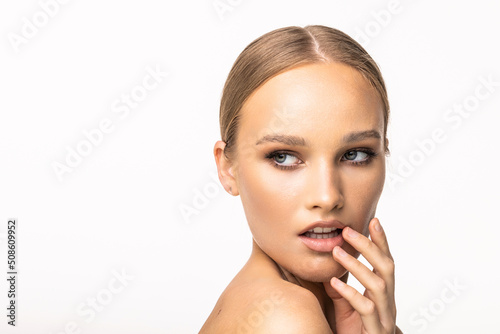 Portrait of beautiful calm woman with young clean healthy skin isolated on white background. Anti-aging and beauty treatment.